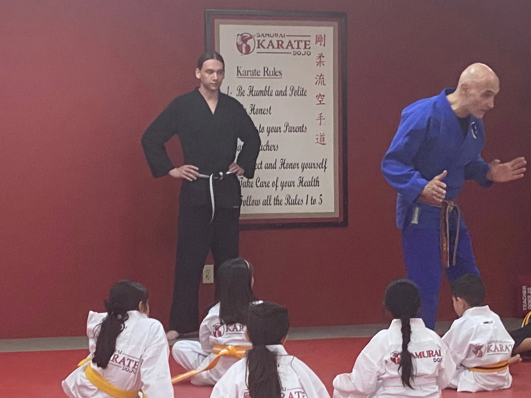 An instructor supervising Is Your Child students closely during class at Samurai Karate Dojo in Houston